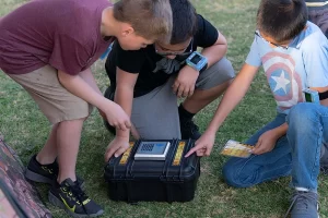 Three boys looking at ZTAG kit