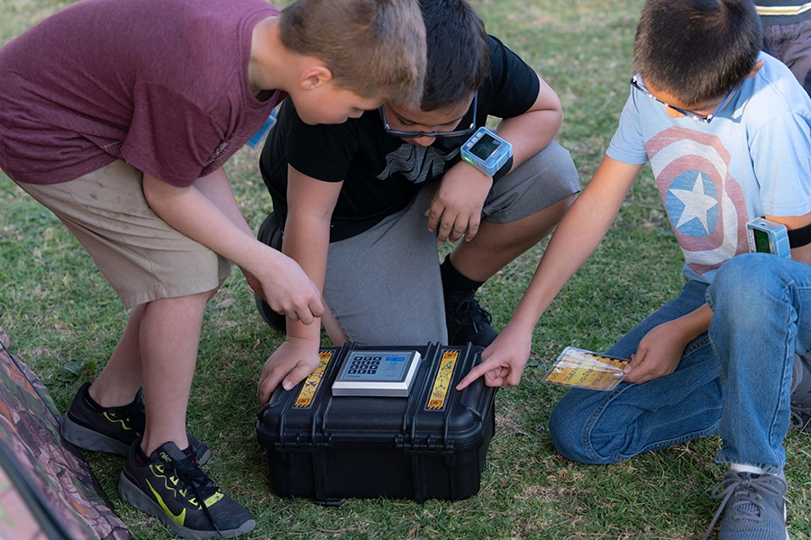 Three boys looking at ZTAG kit